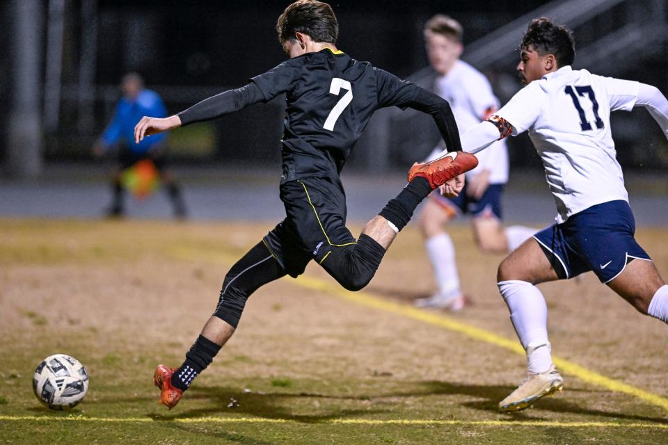 Golden West's Chris Caballeros scores under pressure from Clovis East's Ethan Brusellas in a 2024 Central Section Division II high school boys soccer playoff game on Wednesday, February 14, 2024.