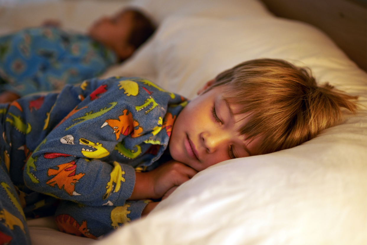 Young boy sleeping in his bed