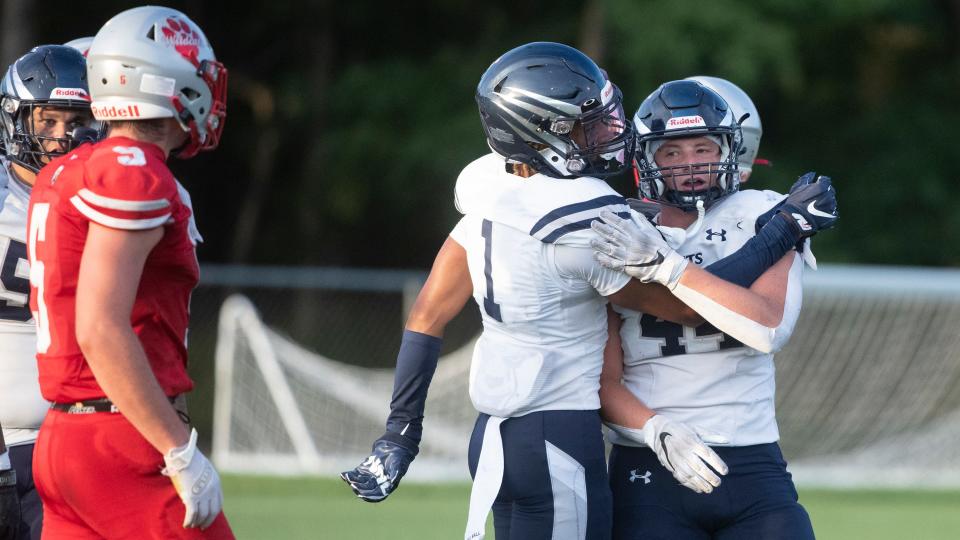 St. Augustine's Matthew Bonczek, right, is congratulated by teammate Na'Cire Christmas after Bonczek made a tackle during the football game between St. Augustine and St. Joseph played at St. Augustine Preparatory School in Richland on Friday, September 2, 2022.  