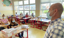 A teacher addresses students returning to school benches on their first day back, after more than four weeks of postponing the learning process due to COVID-19 pandemic, in Kosovo, Pristina on Monday, Sep. 27, 2021. Since the beginning of the pandemic Kosovo has recorded around 160,000 cases with Covid-19, and 2936 deaths. (AP Photo/Visar Kryeziu)