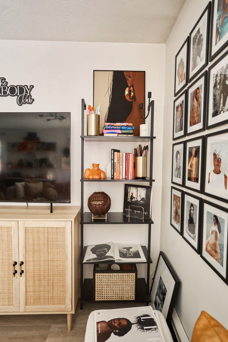 detail of gallery wall and black shelves in white living room