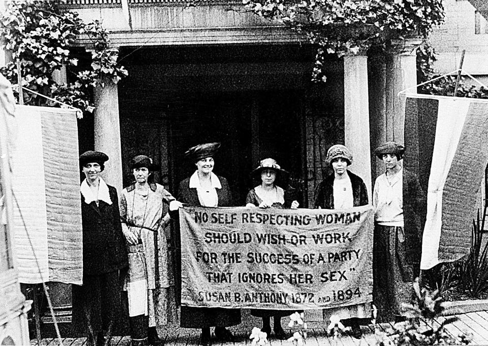 FILE - Chairwoman Alice Paul, second from left, and officers of the National Woman's Party hold a banner with a Susan B. Anthony quote, "No self-respecting woman should wish or work for the success of a party who ignores her sex," in front of the NWP headquarters in Washington in June 1920. “All men are created equal.” Few words in American history are invoked as often as the preamble to the Declaration of Independence, published nearly 250 years ago, and few more difficult to define. (AP Photo, File)