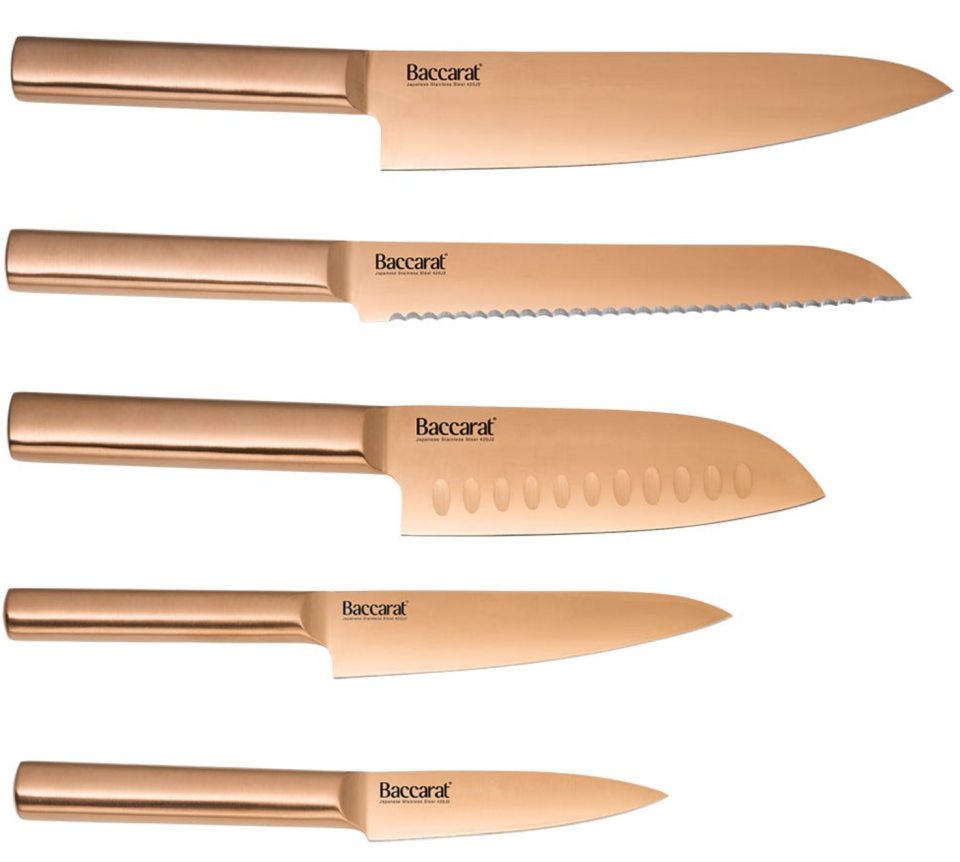 Gold-toned set of five Japanese Baccarat knives on white background