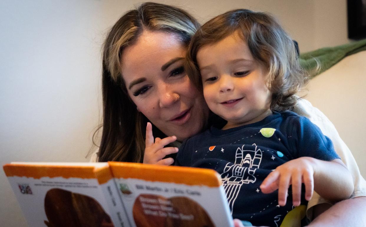 Amanda Holder reads with her 1-year-old son, Graham, at their home in Leander. Holder, a labor and delivery nurse, had preeclampsia when she was 32 weeks pregnant with Graham.