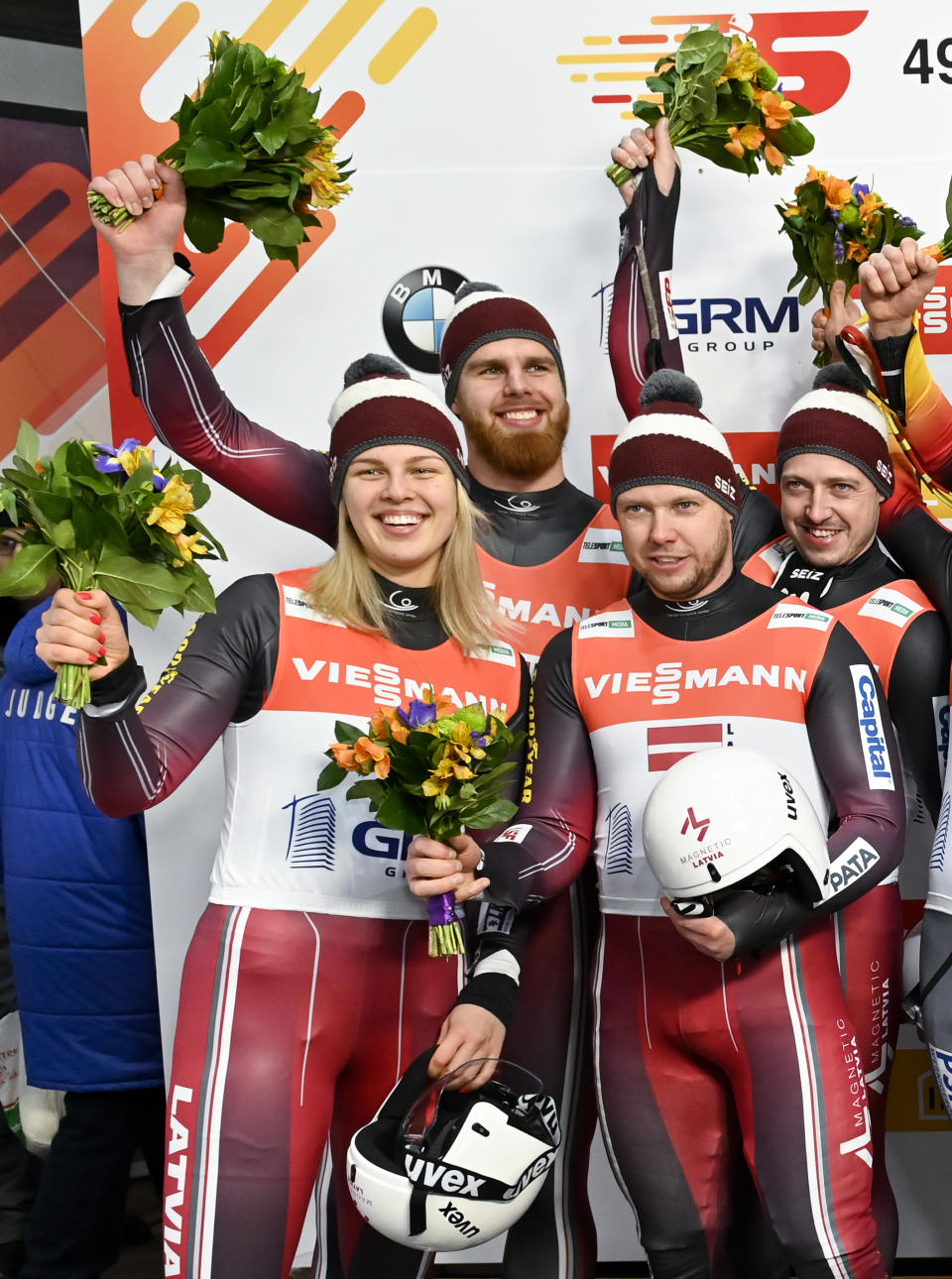 Latvia's team Kendija Aparjode, Kristers Aparjods, Andris Sics, Juris Sics, placed second, celebrate after the World Cup luge relay event in Krasnaya Polyana, near the Black Sea resort of Sochi, southern Russia, Sunday, Feb. 16, 2020. (AP Photo/Artur Lebedev)