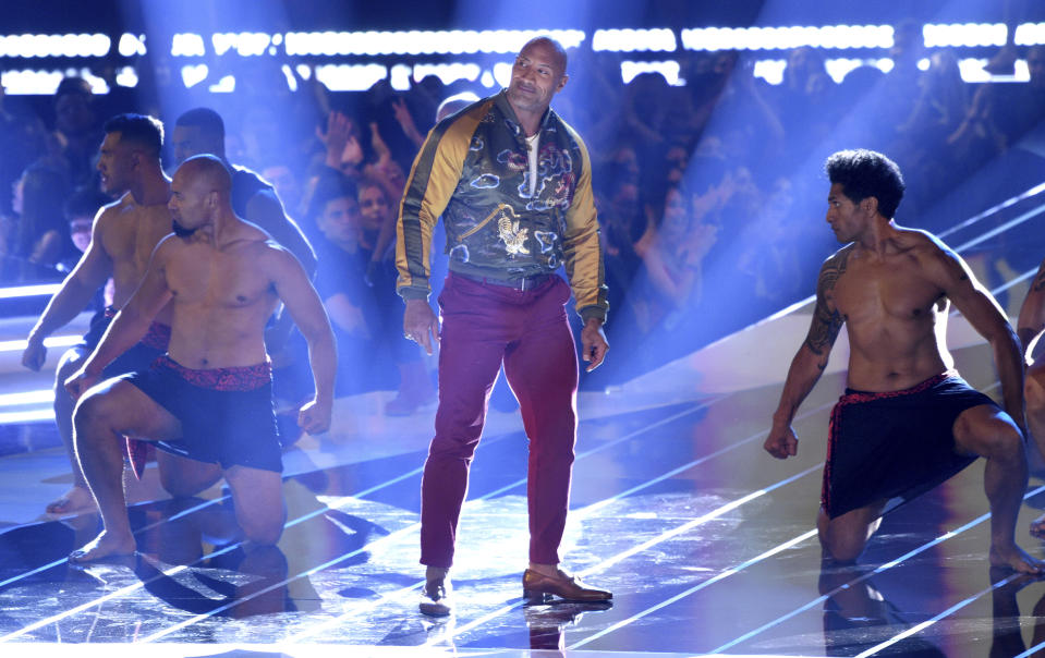 Dwayne Johnson, also known as The Rock, center, accepts the generation award at the MTV Movie and TV Awards on Saturday, June 15, 2019, at the Barker Hangar in Santa Monica, Calif. (Photo by Chris Pizzello/Invision/AP)