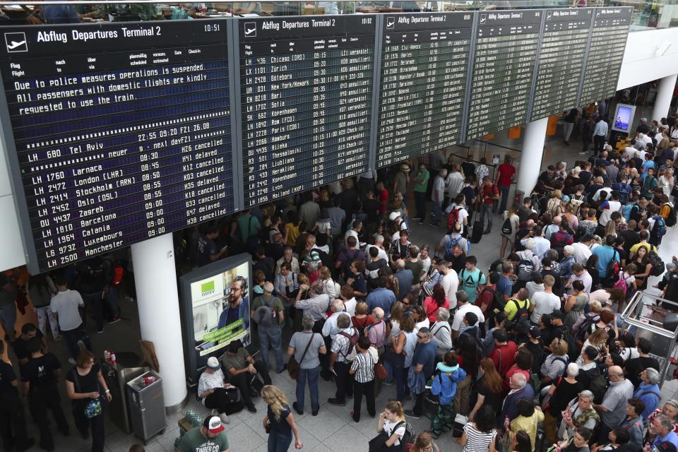 People wait inside the Munich Airport in Munich, Germany, Tuesday, Aug. 27, 2019. Munich Airport says it has closed some of its terminals because a person has likely entered the "clean area" through an emergency exit door. The international airport tweeted Tuesday morning that terminal 2 and areas B and C or terminal 1 had been closed for police operations.(AP Photo/Matthias Schrader)