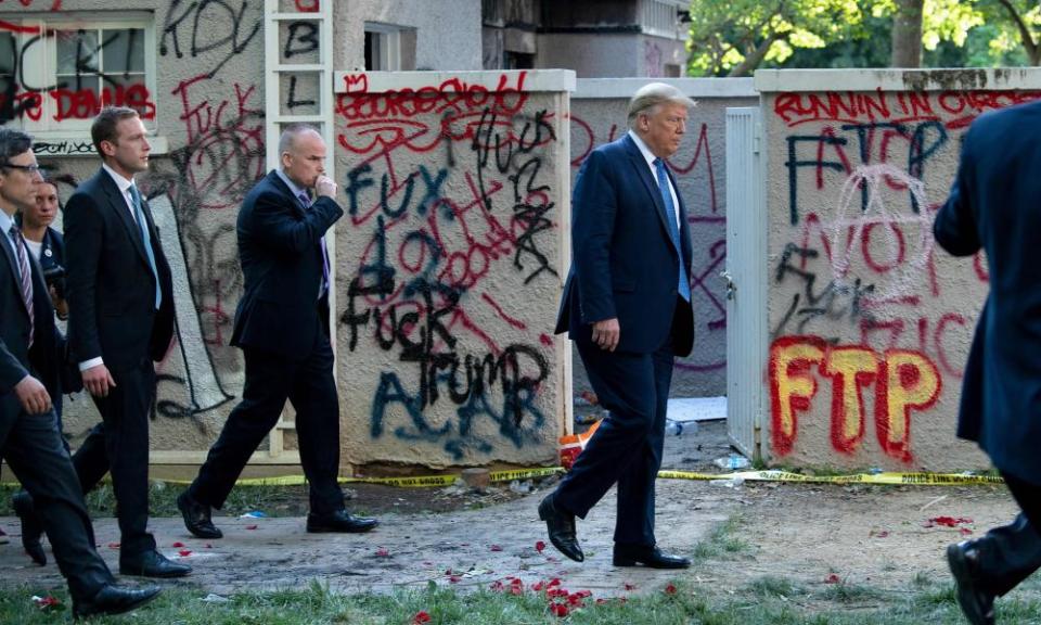 Donald Trump walks back to the White House escorted by the Secret Service after appearing outside St John’s Episcopal church on Monday.