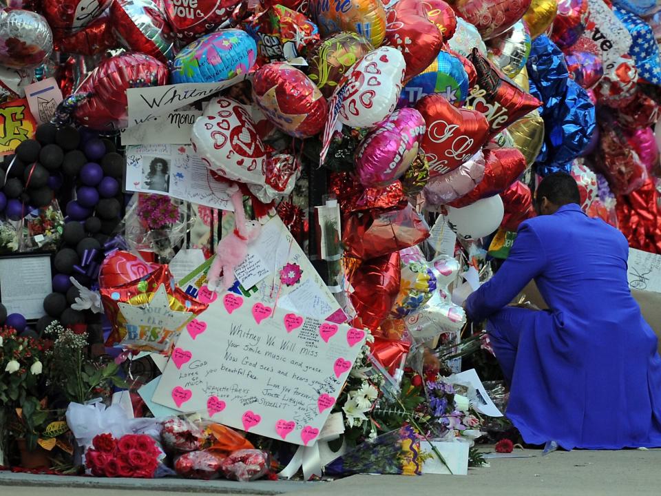 Balloons and flowers put out for Whitney Houston