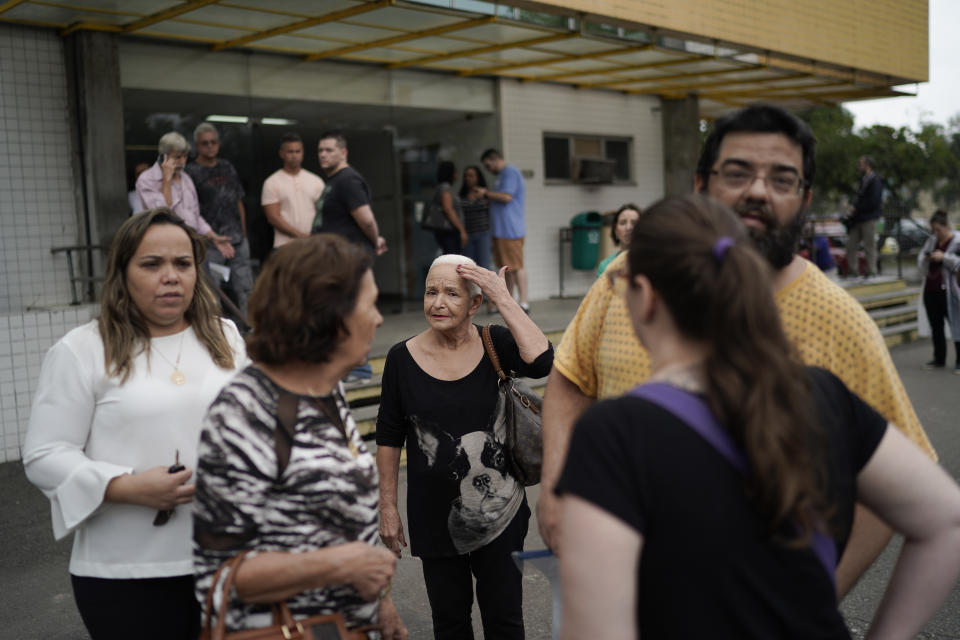 Relatives of one the victims of the Badim Hospital fire leave the Medical Legal Institute morgue in Rio de Janeiro, Brazil, Friday, Sept. 13, 2019. A fire raced through the Badim hospital in Rio de Janeiro, forcing staff to wheel patients into the streets on beds or in wheelchairs and leaving at least 11 people dead, Brazilian officials said Friday. (AP Photo/Leo Correa)