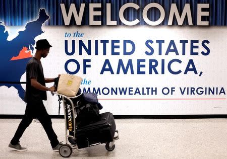 A man exits the transit area after clearing immigration and customs on arrival at Dulles International Airport in Dulles, Virginia, U.S., September 24, 2017. REUTERS/James Lawler Duggan/Files