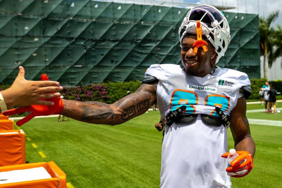 Miami Dolphins wide receiver Erik Ezukanma (87) daps up a fan during Dolphins training camp at Baptist Health Training Complex in Miami Gardens on Saturday, August 6, 2022.