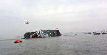 South Korean rescue helicopters fly over a South Korean passenger ship, trying to rescue passengers from the ship in water off the southern coast in South Korea, Wednesday, April 16, 2014. A government office said the passenger ship carrying about 470 people have sent a distress call off the southern coast after it began tittering to one side. (AP Photo/Yonhap) KOREA OUT