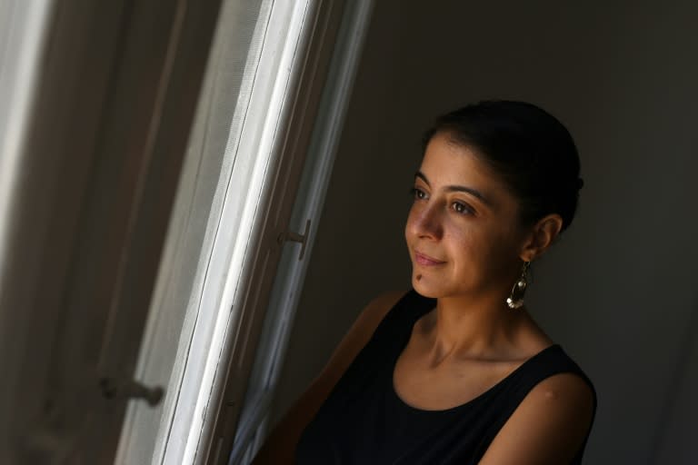 Noha Elostaz, the first woman in Egypt to have won a conviction against a man for sexual harassment, looks out of the window of her apartment in the Egyptian capital Cairo