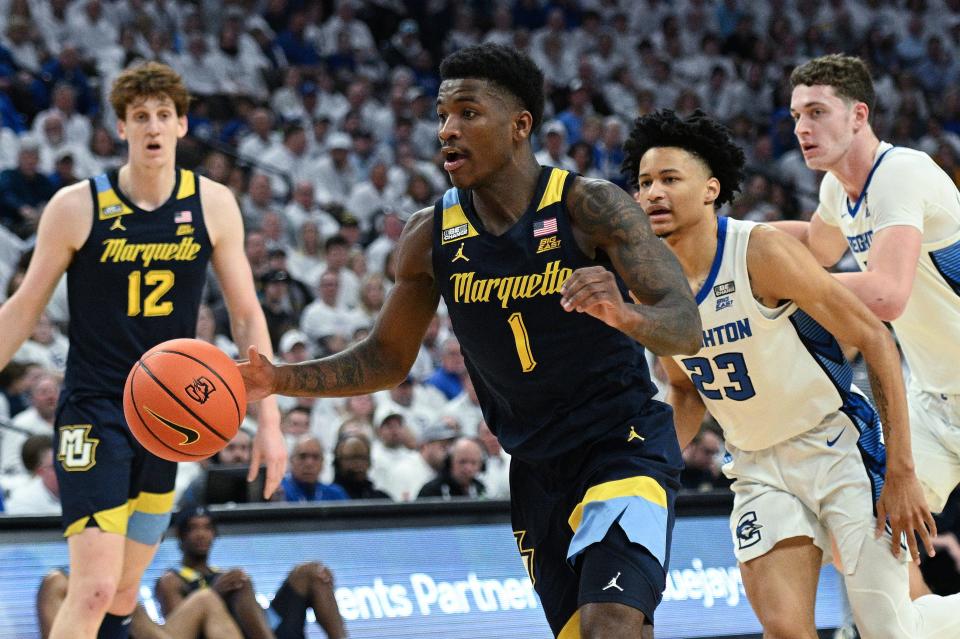 Marquette guard Kam Jones dribbles against Creighton guard Trey Alexander in the first half on Saturday.