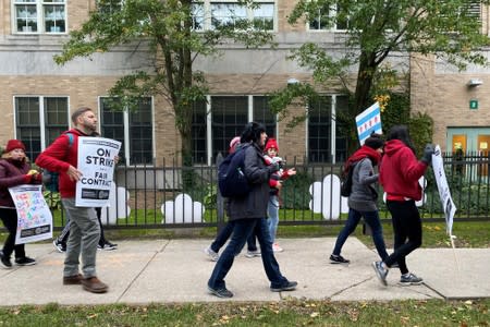 Teachers and parents picket in front of and near Helen C. Pierce School of International Studies during the first day of a teacher strike in Chicago