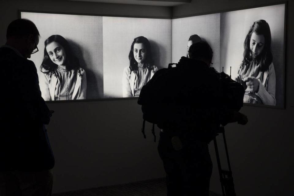 FILE - Journalists take images of the renovated Anne Frank House Museum in Amsterdam, Netherlands, Wednesday, Nov. 21, 2018. The Anne Frank House museum is releasing on Thursday, Aug. 4, 2022, an English-language version of a series of three videos in which an actress playing the young Jewish diarist tells of the last six months of her life, from her arrest to her death in a Nazi concentration camp. (AP Photo/Peter Dejong, File)