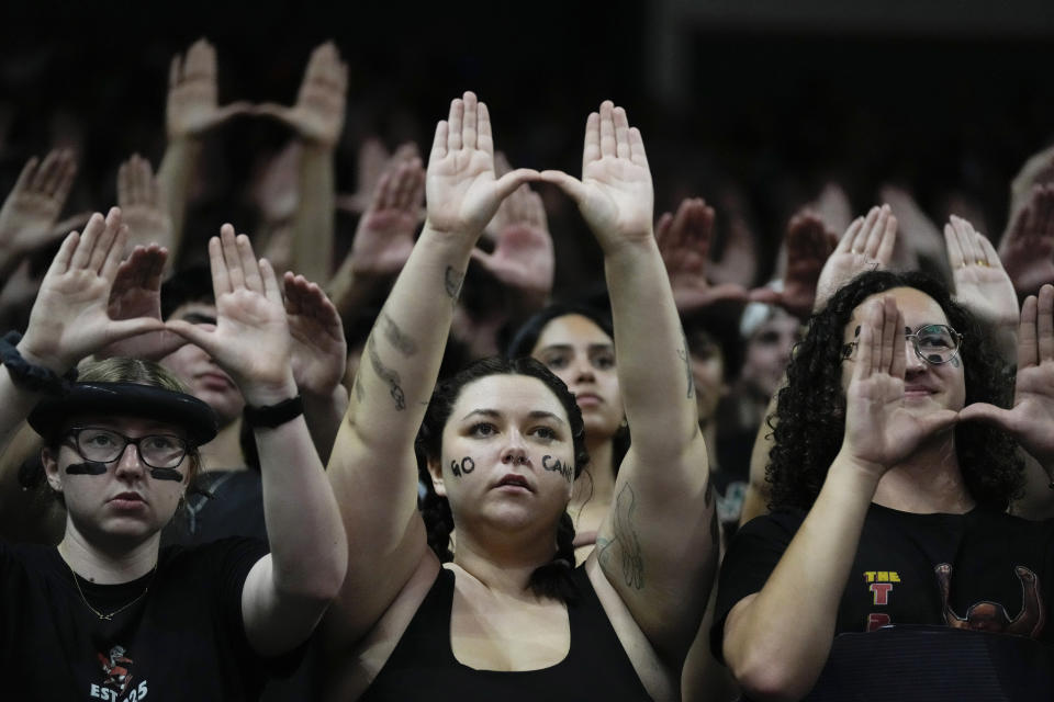 Miami fans root for their team during foul shots, during the first half of an NCAA college basketball game against Pittsburgh, Saturday, March 4, 2023, in Coral Gables, Fla. (AP Photo/Rebecca Blackwell)