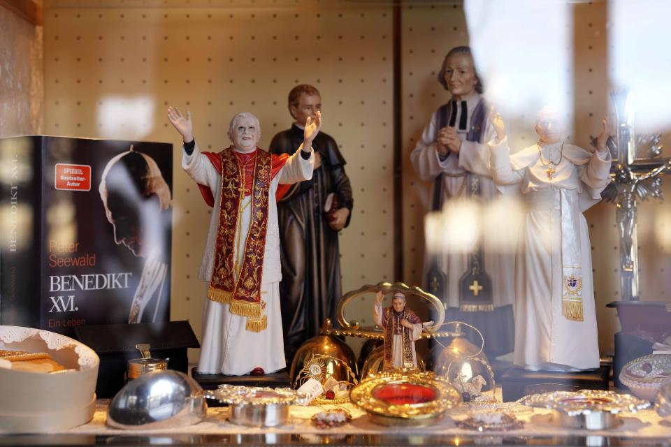 Souvenirs of Pope Benedict XVI are displayed at the main square 'Kapellplatz' in Altoetting, some 90 kilometers (about 55 miles) east of Munich near Marktl, the birthplace of Pope emeritus Benedict XVI, Germany, Thursday, Dec. 29, 2022. The health of Pope Emeritus Benedict XVI has worsened due to his age, and doctors are constantly monitoring the 95-year-old's condition, the Vatican said Wednesday.(AP Photo/Matthias Schrader)