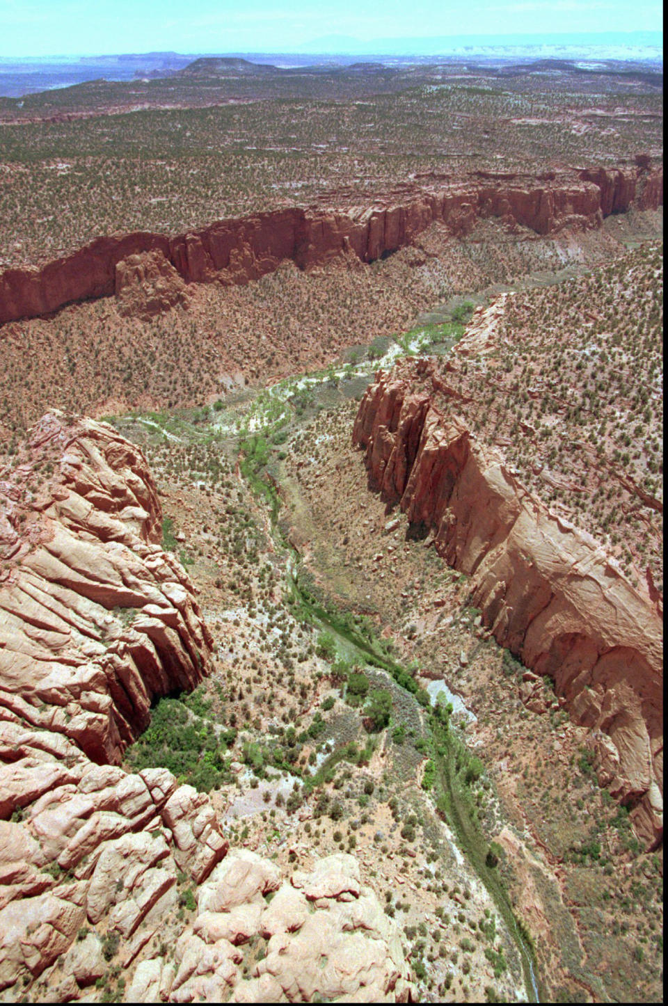 FILE - This May 30, 1997, file photo, shows the varied terrain of Grand Staircase-Escalante National Monument near Boulder, Utah. The U.S. government’s final management plan for lands in and around the Utah national monument that President Donald Trump downsized doesn’t include many new protections for the cliffs, canyons, waterfalls and arches found there, but it does include a few more safeguards than were in a proposal issued last year. The Bureau of Land Management’s plan for the Grand Staircase-Escalante National Monument in southwestern Utah codifies that the lands cut out of the monument will be open to mineral extraction such as oil, gas and coal as expected, according to a plan summary the agency provided to The Associated Press. (AP Photo/Douglas C. Pizac, File)