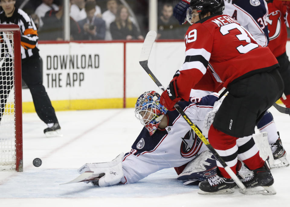 New Jersey Devils right wing Nicholas Merkley (39) watches as his shot comes out of the net after he scored his first career NHL goal, against Columbus Blue Jackets goaltender Elvis Merzlikins (90), during the second period of a hockey game, Sunday, Feb. 16, 2020, in Newark, N.J. (AP Photo/Kathy Willens)