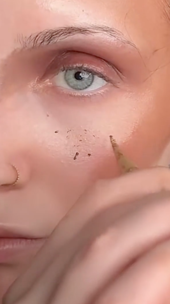 Ogle uses henna to create freckles.