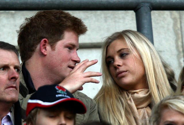 Prince Harry and Chelsy Davy watching from the stands during a rugby match at Twickenham