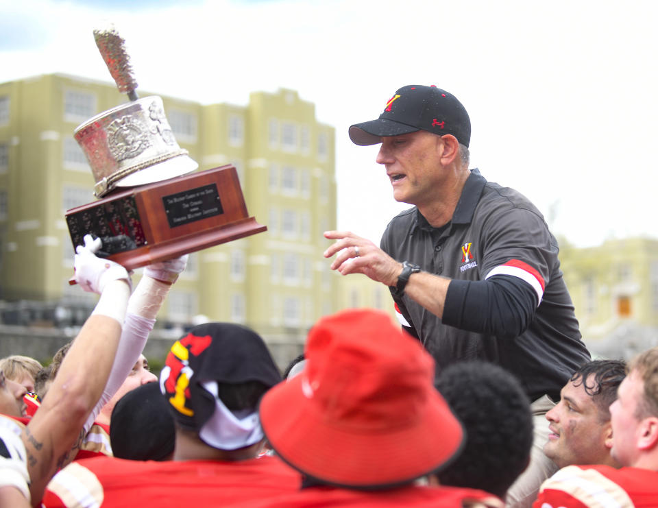 VMI head coach Scott Wachenheim is lifted up by his team after they defeated The Citadel 31-17 to win the Southern Conference Championship, Saturday, April 17, 2021, in Lexington, Va. (David Hungate/Roanoke Times via AP)