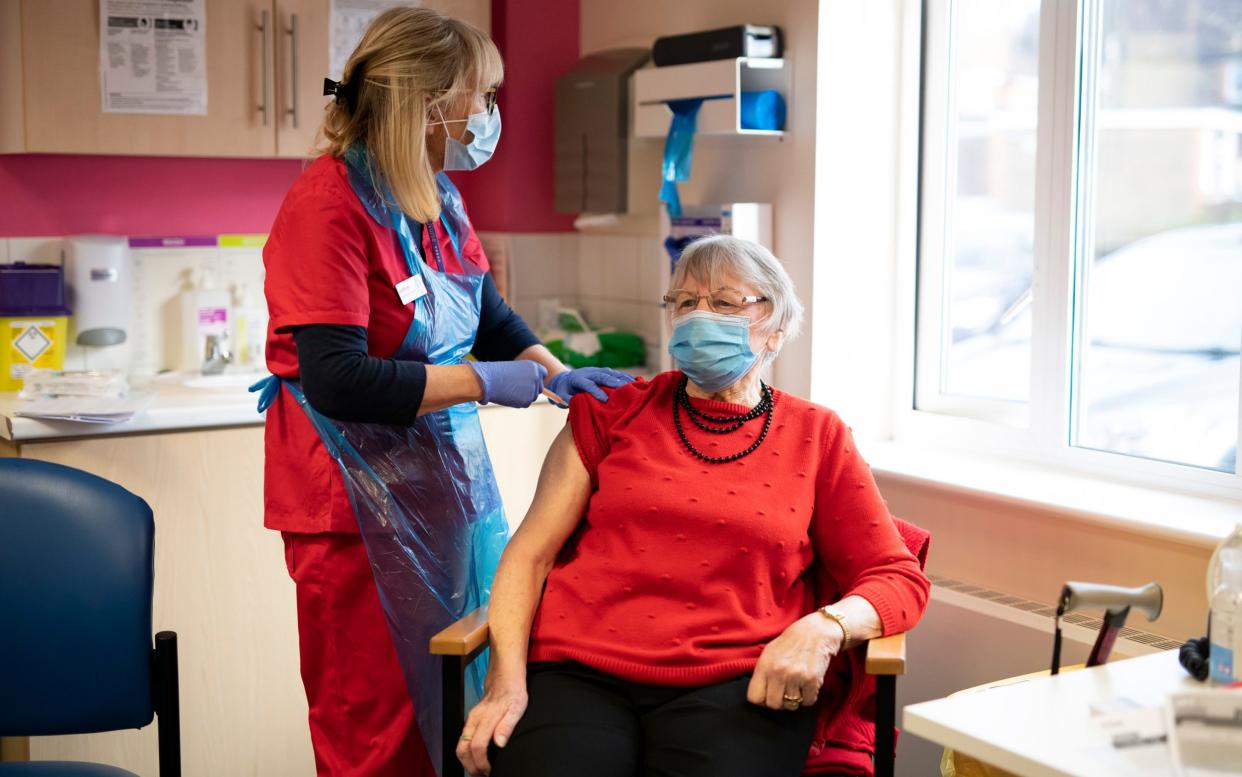 A patient gets their first dose of the Oxford/AstraZeneca Covid vaccine at a GP practice in Horsham, West Sussex - Christopher Pledger 