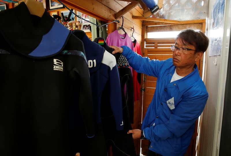 Koji Suzuki, a surfer and a surf shop owner, works at his shop in Minamisoma