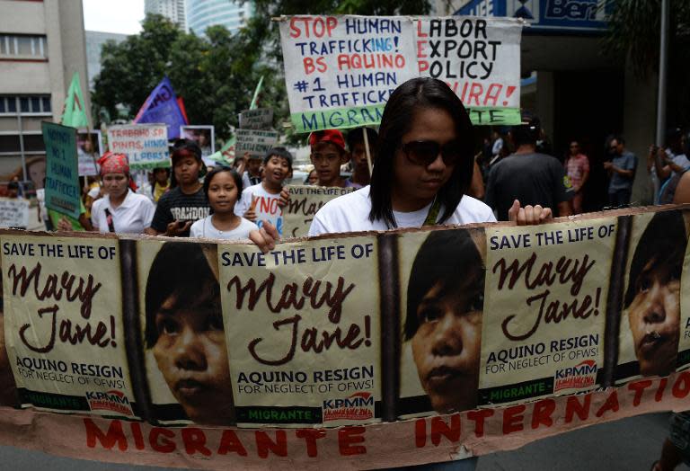 Activists holding a streamer march towards the Indonesian embassy in Manila on April 24, 2015, for a protest in support of Filipina Mary Jane Veloso