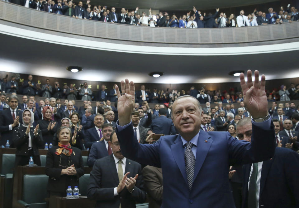 Turkey's President Recep Tayyip Erdogan gestures as he arrives to address supporters at the parliament, in Ankara, Turkey, Tuesday, Oct. 30, 2018. Erdogan said the Turkish prosecutor repeated to his Saudi counterpart Turkey's extradition request of 18 suspects detained in Saudi Arabia for the Oct. 2 killing to be put on trial in Istanbul. (Presidential Press Service via AP, Pool)