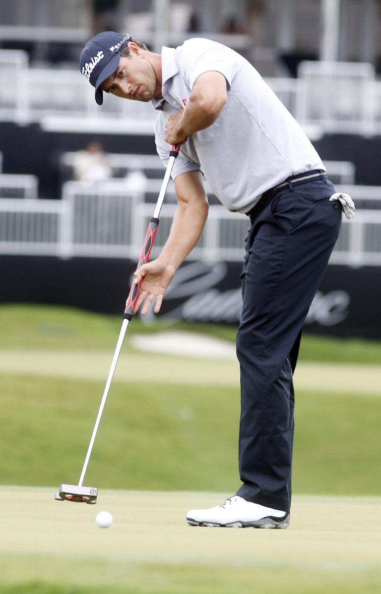 Adam Scott, of Australia, watches his shot on the ninth hole during the first round of the Cadillac Championship golf tournament on Thursday, March 6, 2014, in Doral, Fla. (AP Photo/Marta Lavandier)