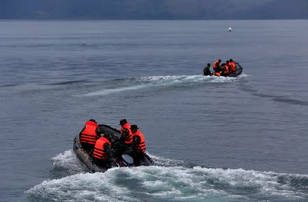 FILE PHOTO: Rescue team members use rubber boats during a search operation for missing passengers after a ferry sank earlier this week in Lake Toba in Simalungun, North Sumatra, Indonesia, June 23, 2018. REUTERS/Beawiharta/File Photo