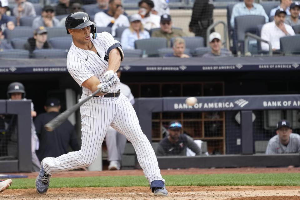 New York Yankees' Giancarlo Stanton hits a two-run double in the seventh inning of a baseball game against the Minnesota Twins, Saturday, April 15, 2023, in New York. (AP Photo/Mary Altaffer)