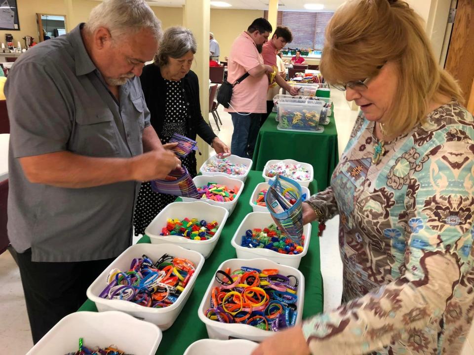 From left to right, Second Branch Baptist Church members Terry Newcomb, Eggie Wilcox, Jason McName, Aidan McName and Martha Flory pack school supply kits for Operation Christmas Child shoebox gifts.