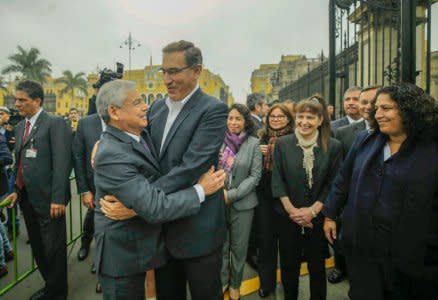 Peruvian President Martin Vizcarra (C) greets Prime Minister Cesar Villanueva outside Government Palace in Lima, Peru. Undated photo released on September 19, 2018.  Courtesy of Agencia Andina/Handout via REUTERS