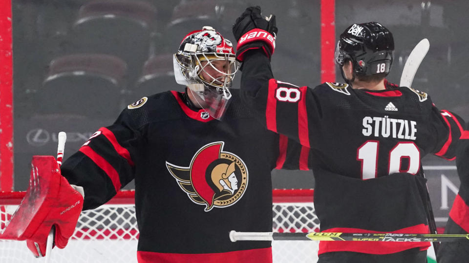 OTTAWA, ON - MARCH 22:  Making his NHL debut as a starting goaltender, Filip Gustavsson #32 of the Ottawa Senators celebrates his first career NHL win against the Calgary Flames with teammate Tim St&#xc3;&#xbc;tzle #18 at Canadian Tire Centre on March 22, 2021 in Ottawa, Ontario, Canada.  (Photo by Andre Ringuette/NHLI via Getty Images)