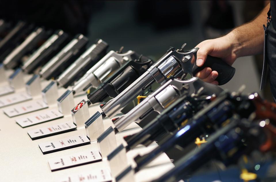 FILE - In this Jan. 19, 2016, file photo, handguns are displayed at the Smith & Wesson booth at the Shooting, Hunting and Outdoor Trade Show in Las Vegas. The gun industry is gathering for its annual conference, in January 2020, amid a host of uncertainty: slumping gun sales, a public increasingly agitating for restrictions on access to firearms and a presidential campaign that threatens gun rights like perhaps no other time in modern American history. (AP Photo/John Locher, File)