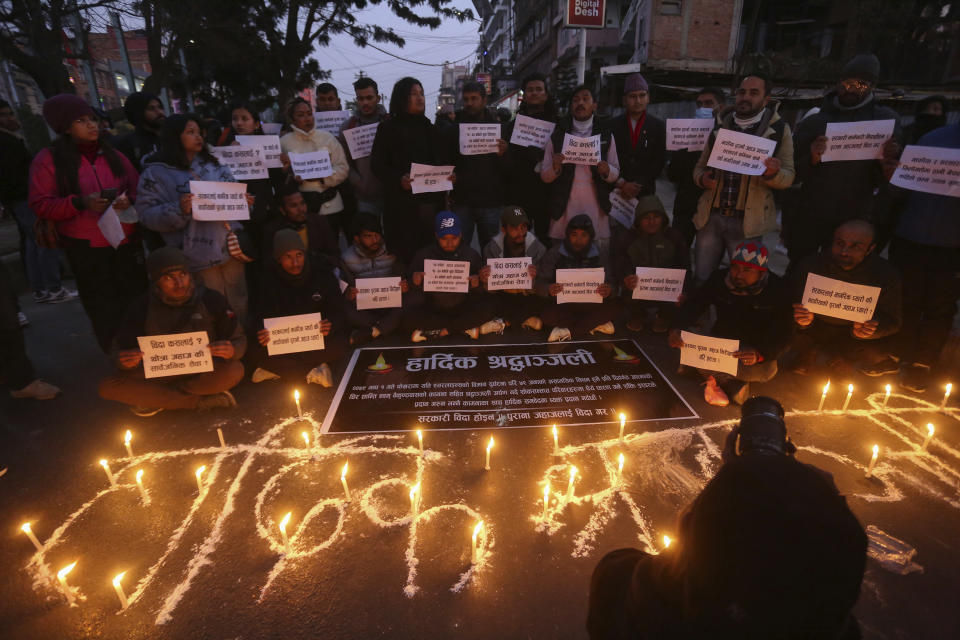 People observe a candlelight vigil in memory of victims of a plane crash in Kathmandu, Nepal, Monday, Jan. 16, 2023. Nepal began a national day of mourning Monday as rescue workers resumed the search for six missing people a day after a plane to a tourist town crashed into a gorge while attempting to land at a newly opened airport, killing at least 66 of the 72 people aboard in the country's deadliest airplane accident in three decades. (AP Photo/Bikram Rai)