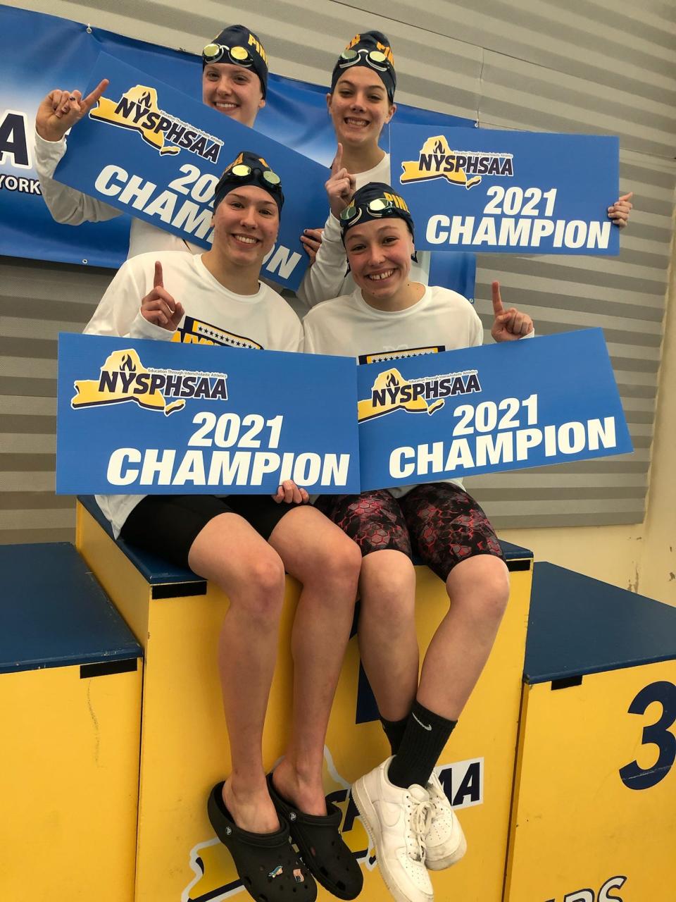 Elishka Hajek, Samantha McKee, Cora Mance and Mackenzie Gula hold up championship signs after winning the 200-yard freestyle relay at the 2021 NYSPHSAA Swimming & Diving Championships and breaking a Section 9 record. McKee and Gula are back for the 2023 finals. KATHY GALLAGHER