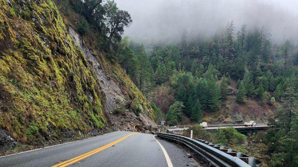 PHOTO: Heavy machinery is shown removing a rock slide on State Route 299 in Burnt Ranch, Calif., Dec. 31, 2022 (Micah Crockett/AP)