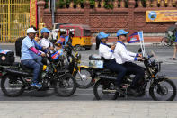 Cambodian People's Party (CPP) supporters drive motorbikes during the last day of campaigning ahead of the June 5 communal elections, in Phnom Penh, Cambodia, Friday, June 3, 2022. (AP Photo/Heng Sinith)