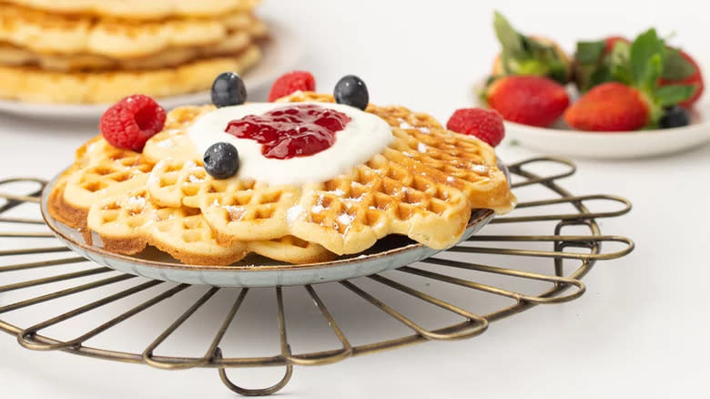 Waffles with fruit, jelly, and cream