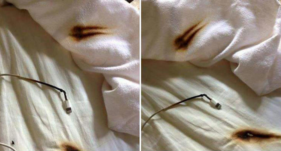 Scorch marks from a phone charger on a bed with white sheets.