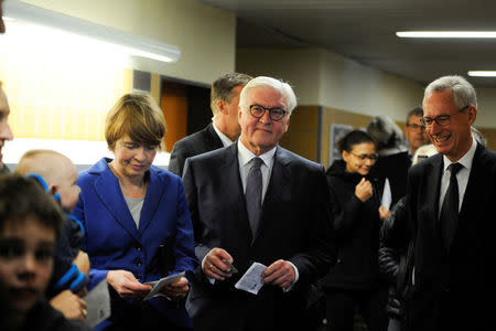 German President Frank-Walter Steinmeier waits in line to cast his vote on election day in Berlin, Germany September 24, 2017. REUTERS/Stefanie Loos