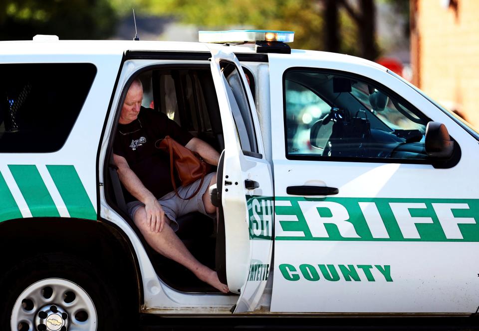 A man sits in Sheriff’s vehicle following the shooting (AP)