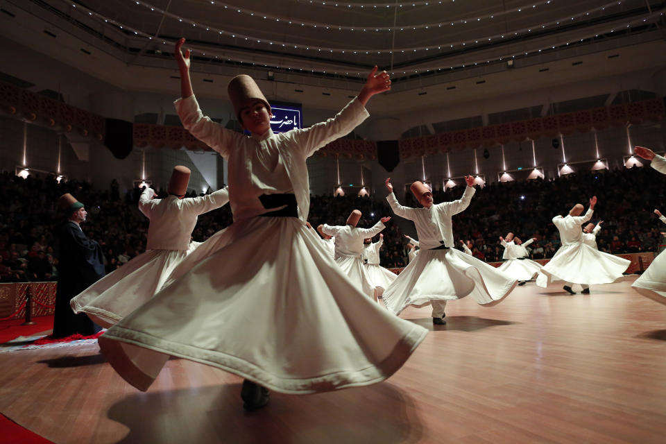 In this photo taken on Sunday, Dec. 16, 2018, whirling dervishes of the Mevlevi order perform during a Sheb-i Arus ceremony in Konya, central Turkey. Every December the Anatolian city hosts a series of events to commemorate the death of 13th century Islamic scholar, poet and Sufi mystic Jalaladdin Rumi. (AP Photo/Lefteris Pitarakis)