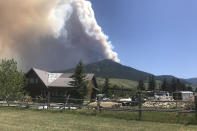 In this photo provided by Jim Bentler, the Robertson Draw fire is seen burning south of Red Lodge, Mont., on Tuesday, June 15, 2021. Authorities warned of extreme wildfire danger in Montana and Wyoming Tuesday as a sweltering heat wave was forecast to intensify across large parts of the two states after already delivering record high temperatures. (Jim Bentler via AP)