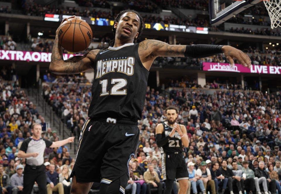 Memphis Grizzlies guard Ja Morant reacts after drawing a foul during the second half of the team's NBA basketball game against the Denver Nuggets on Tuesday, Dec. 20, 2022, in Denver. (AP Photo/David Zalubowski)